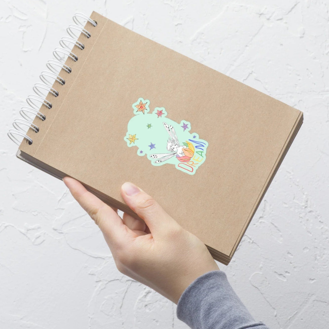 dream fairy sticker with aqua background on a flip notebook