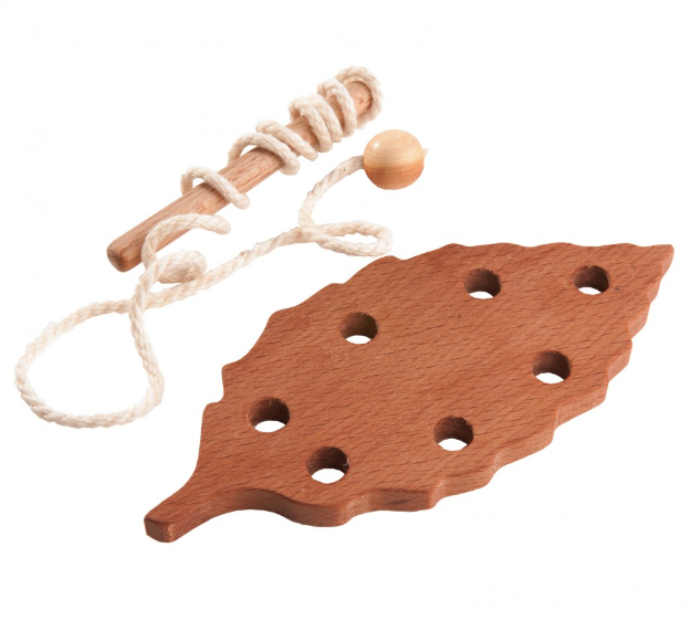 Wooden leaf-shaped toy with holes and a stick on a white background