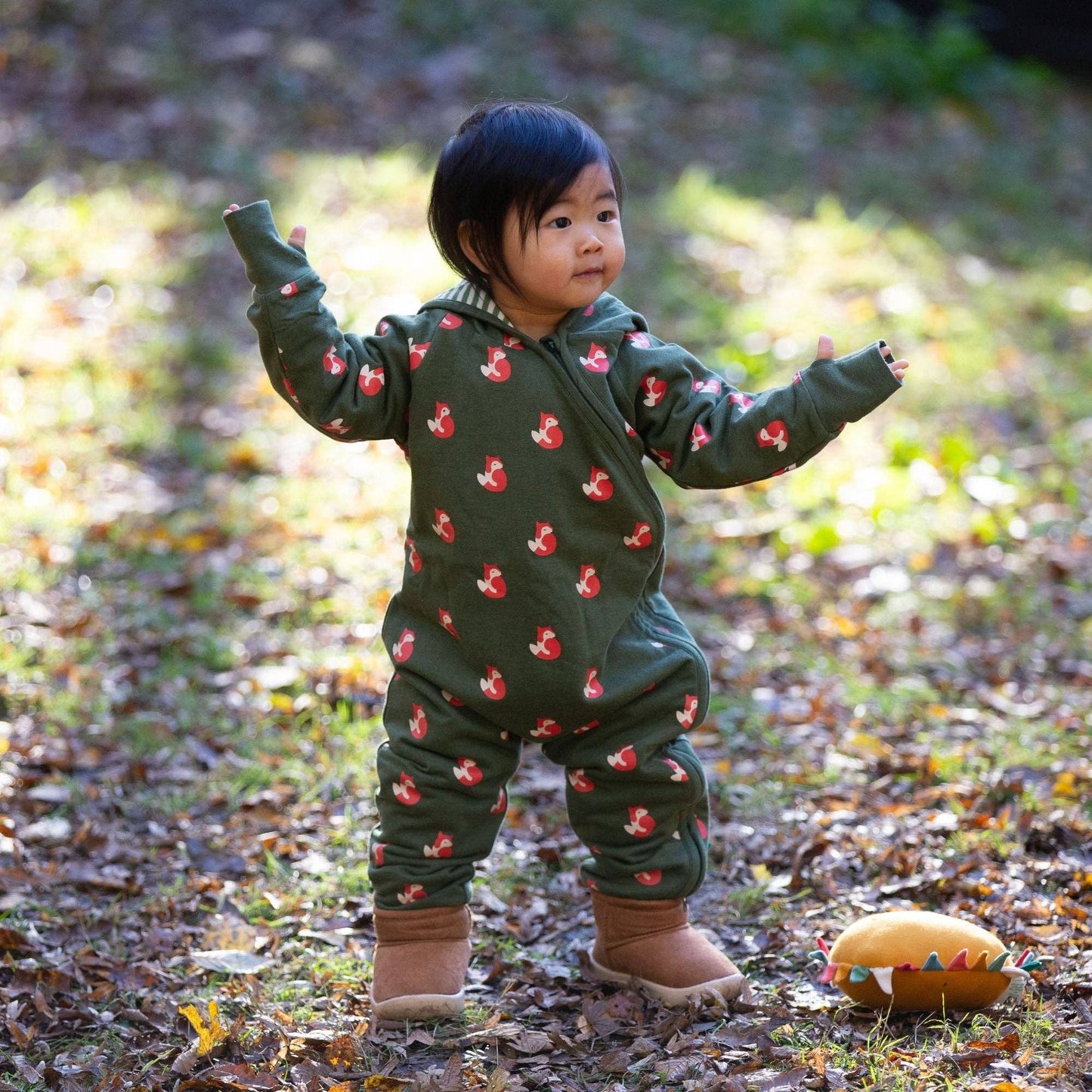 Toddler standing outdoors wearing foxes snug-as-a-bug suit