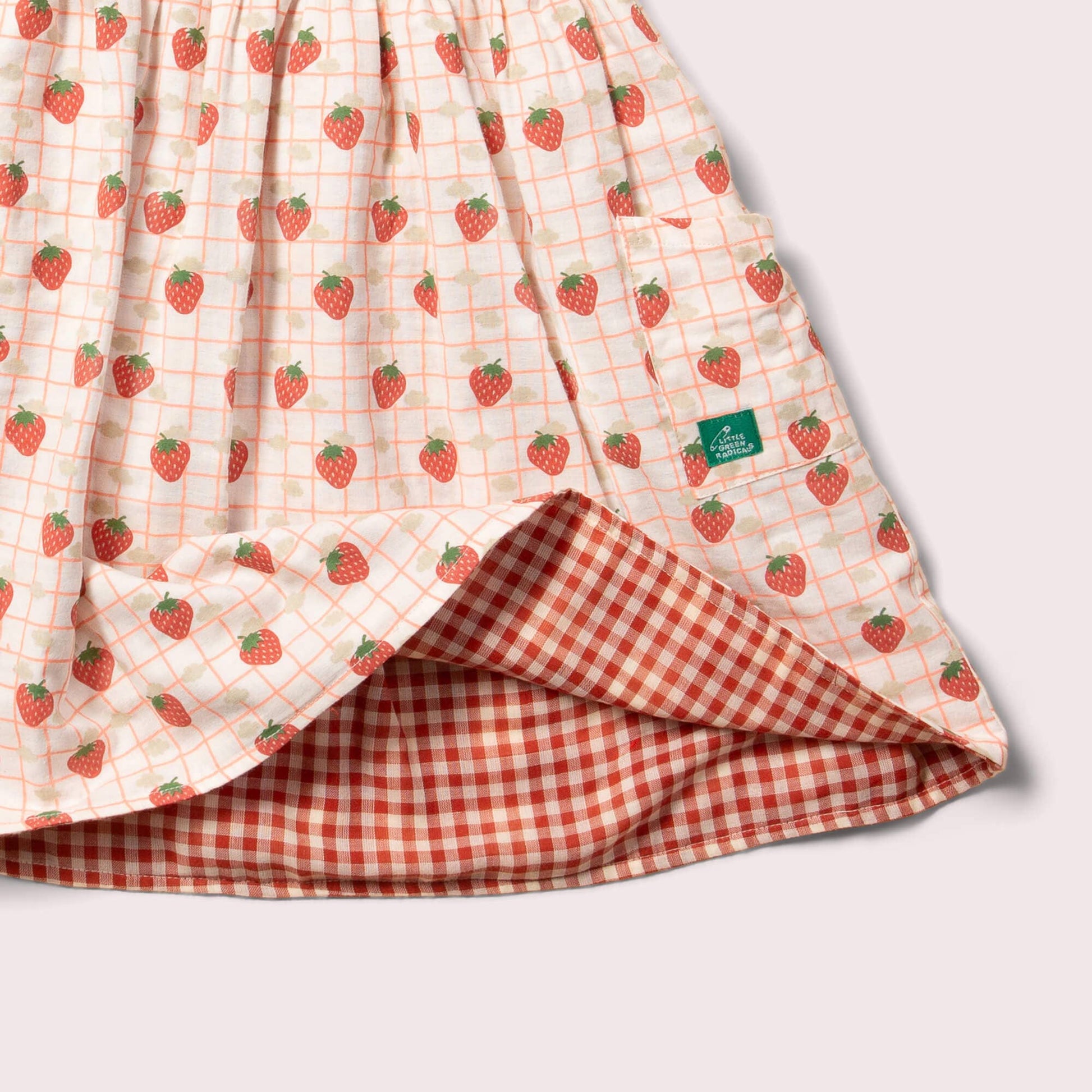 side pocket detail for reversible strawberry pinny dress on the strawberries print side