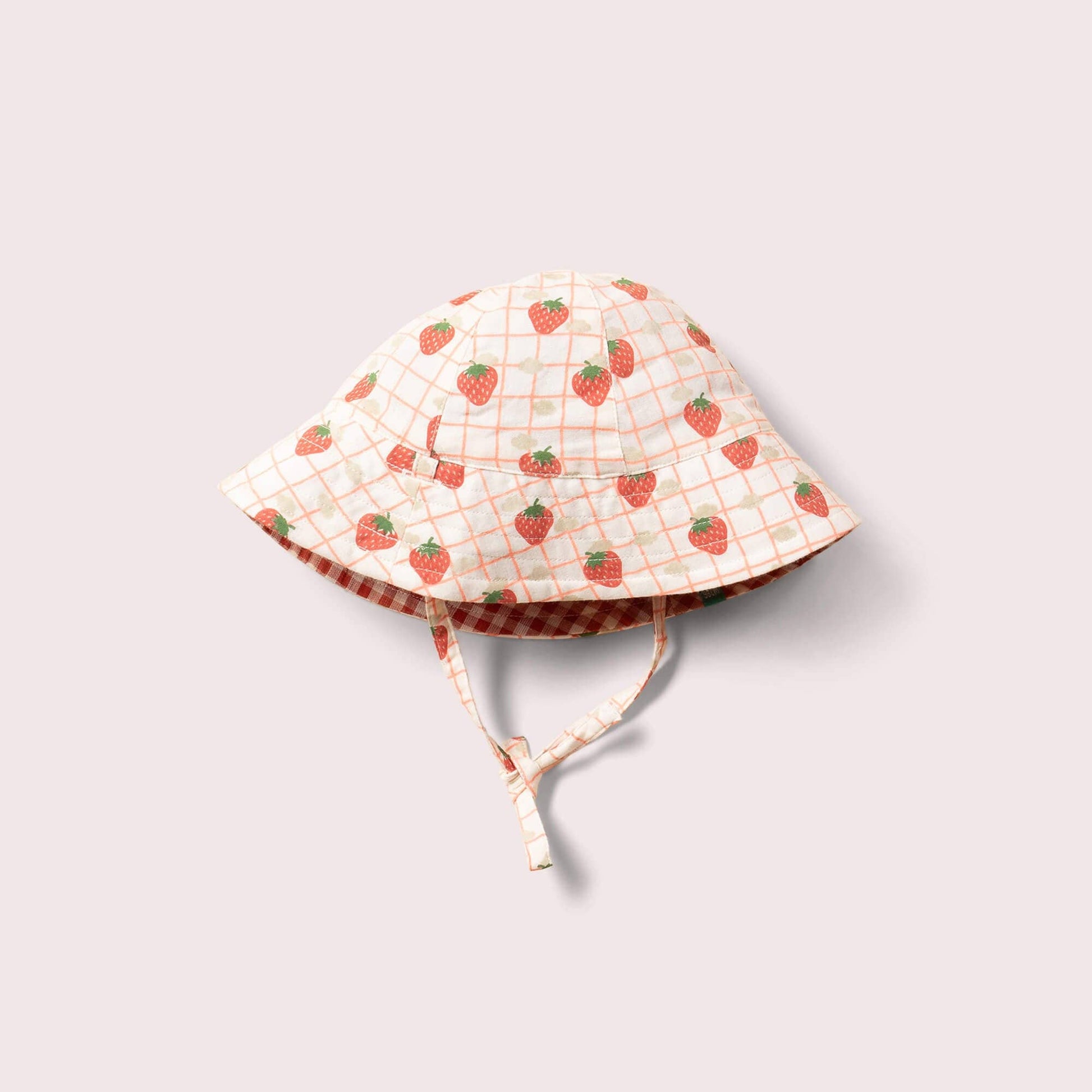 organic reversible strawberry hat laid flat on the strawberries print side