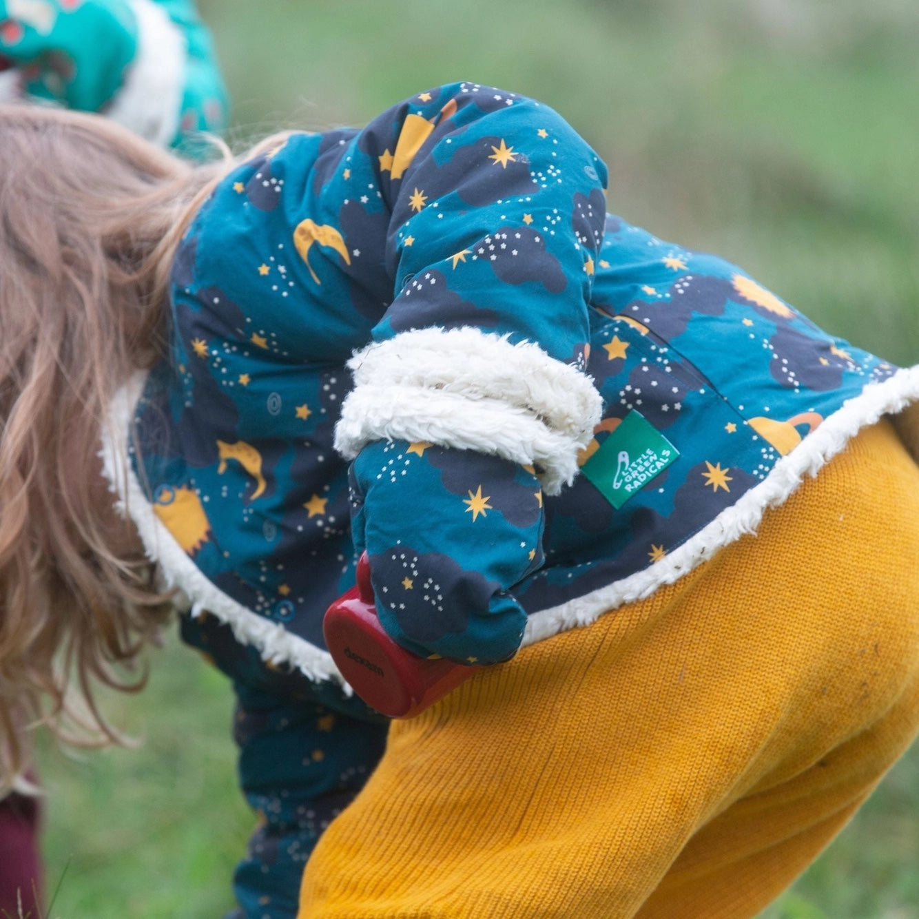 child playing outside wearing Saturn nights sherpa lined mittens