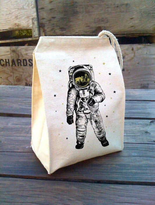 Canvas lunch bag with an astronaut design on a wooden table