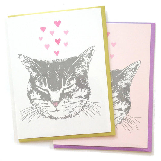 Two greeting cards with a cat illustration and heart designs on a white background.