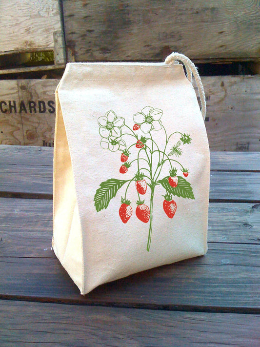 Canvas lunch bag with strawberry print on a wooden table