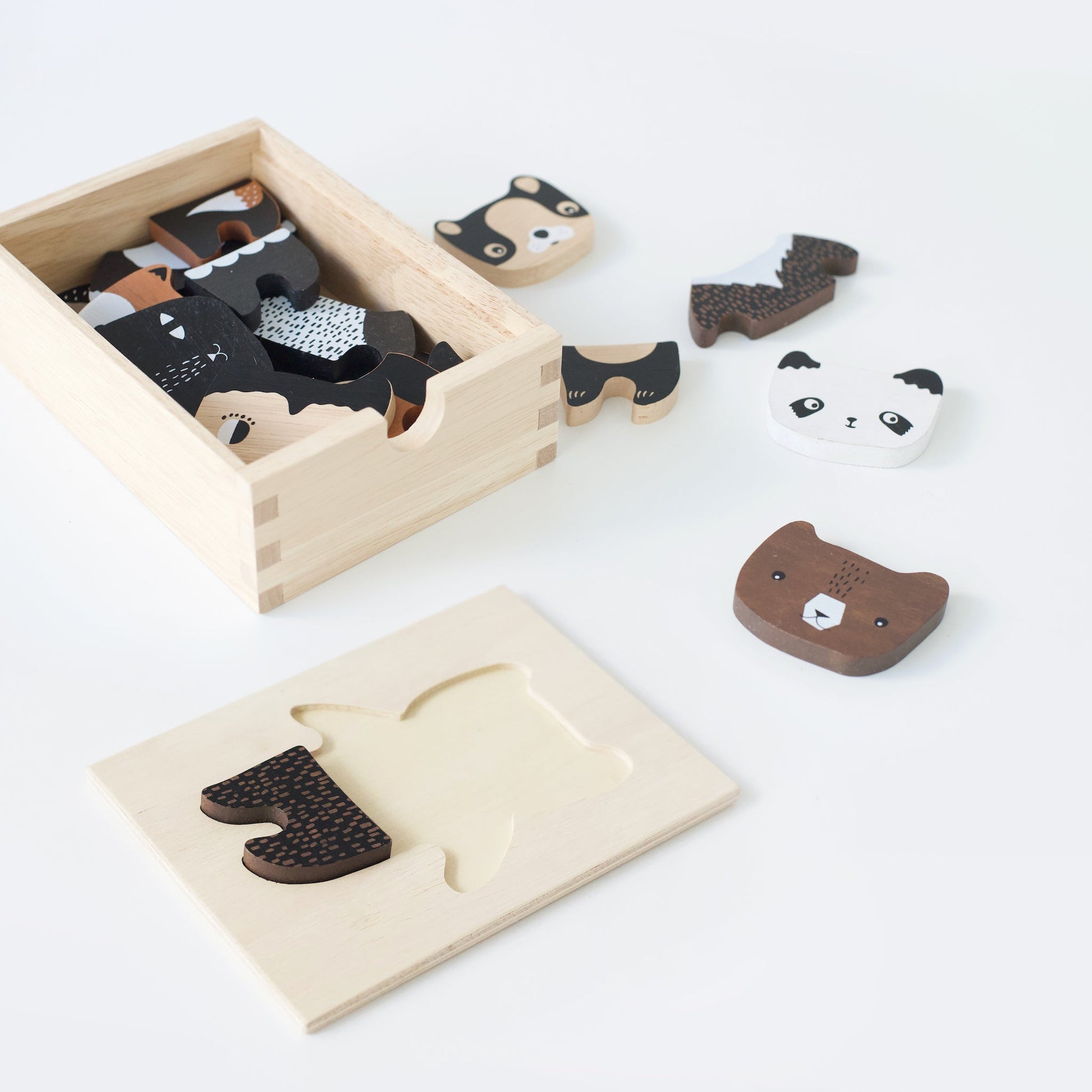 Wooden animal puzzle set with pieces on a white background