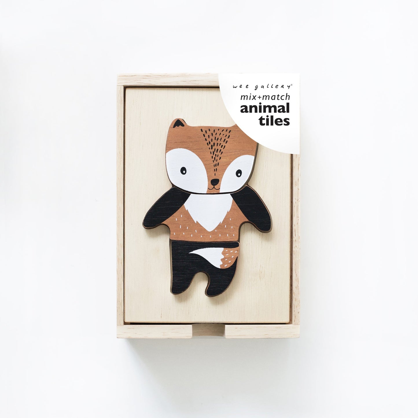 Wooden fox toy in a box with 'mix and match animal tiles' packaging on a white background