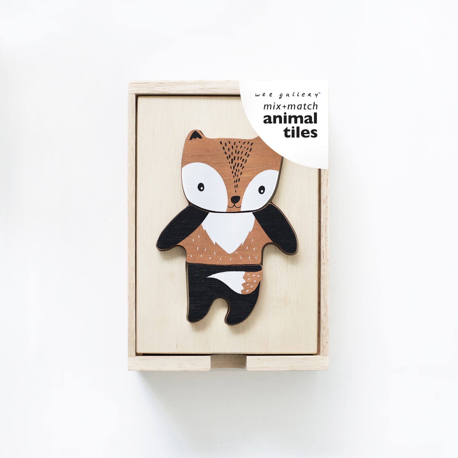 Wooden fox toy in a box with 'mix and match animal tiles' packaging on a white background