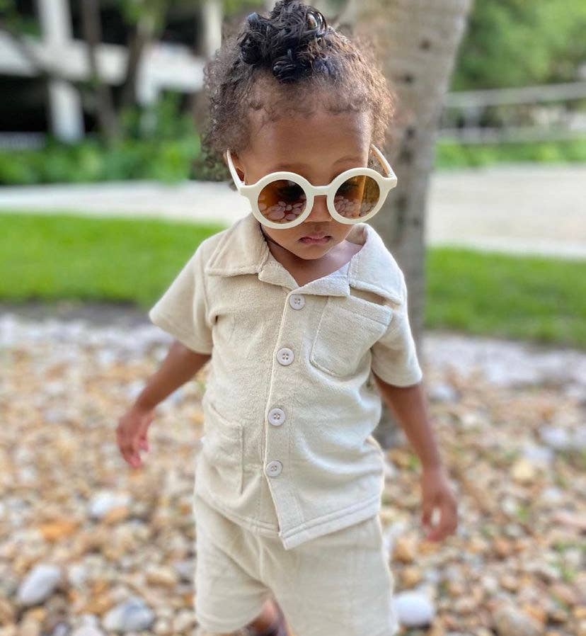 child standing outside wearing off white eco sunglasses