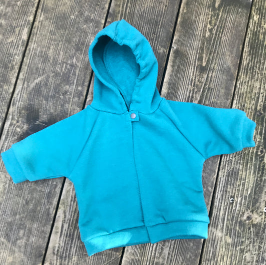 teal fleece hoodie on a wooden surface