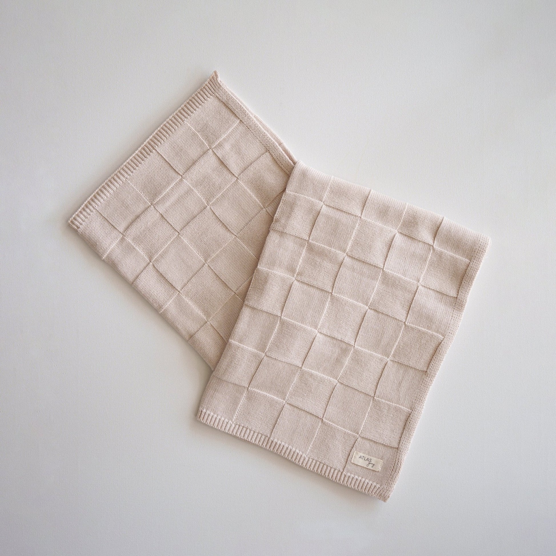 Beige woven placemats on a light gray background