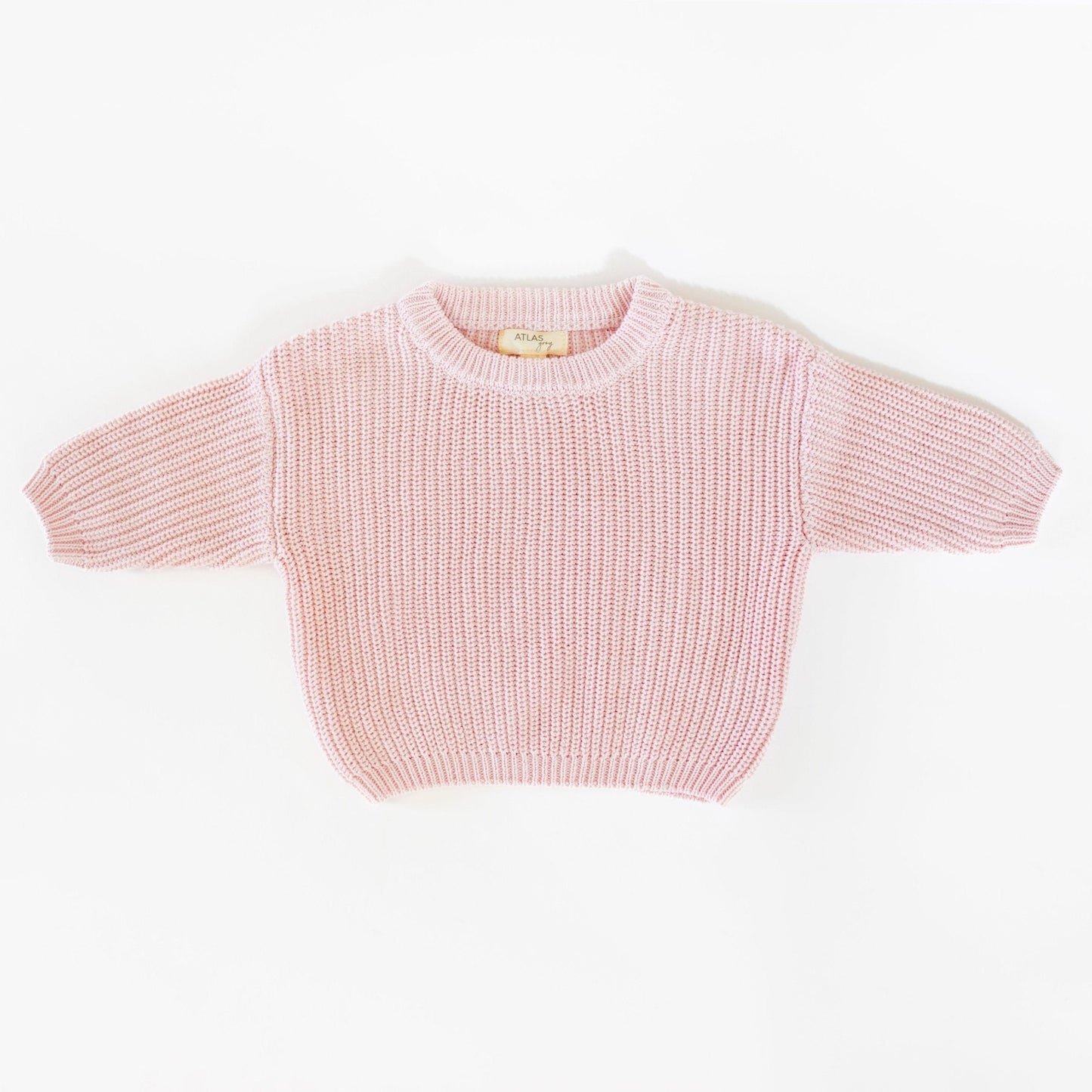 Pink knitted sweater on a white background