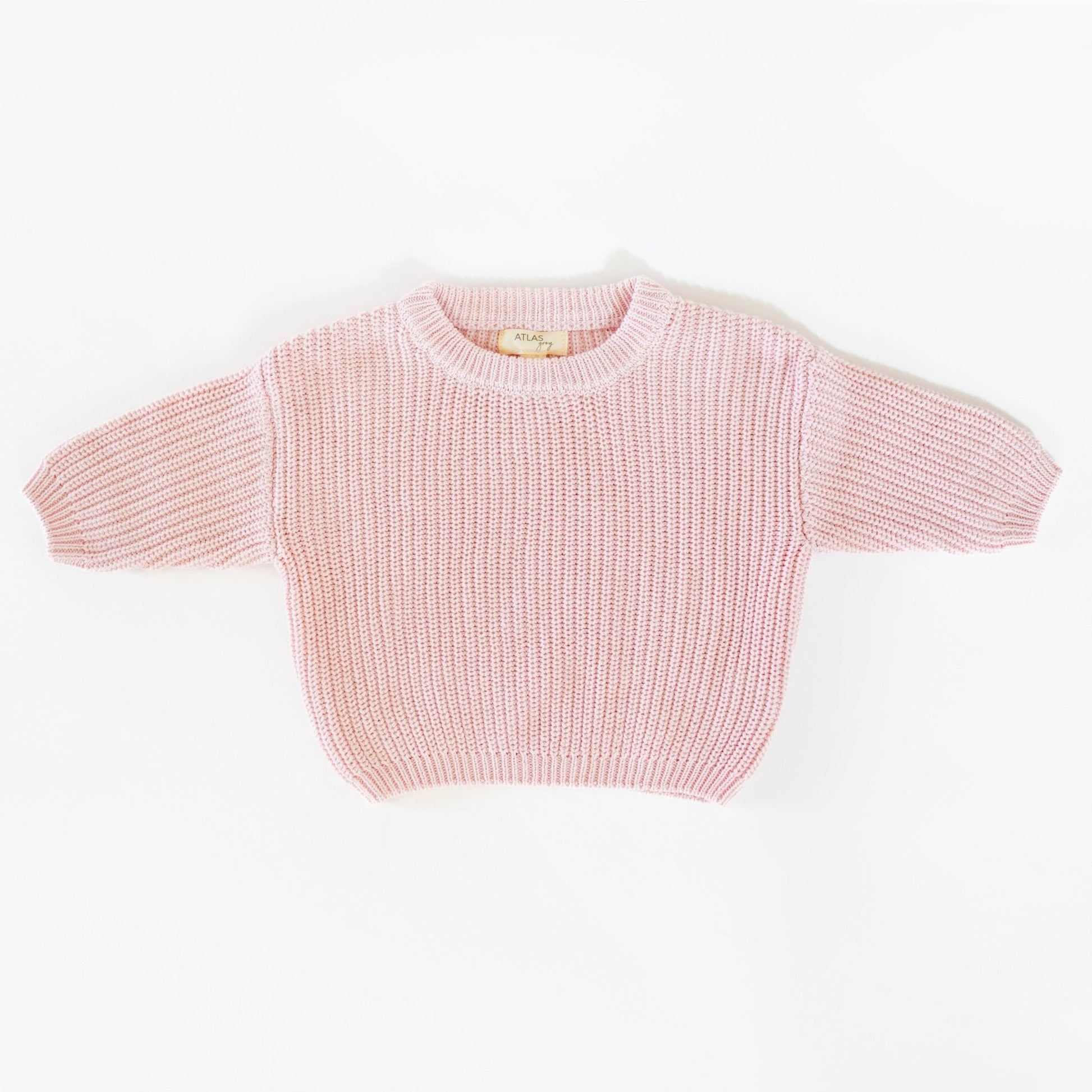 Pink knitted sweater on a white background