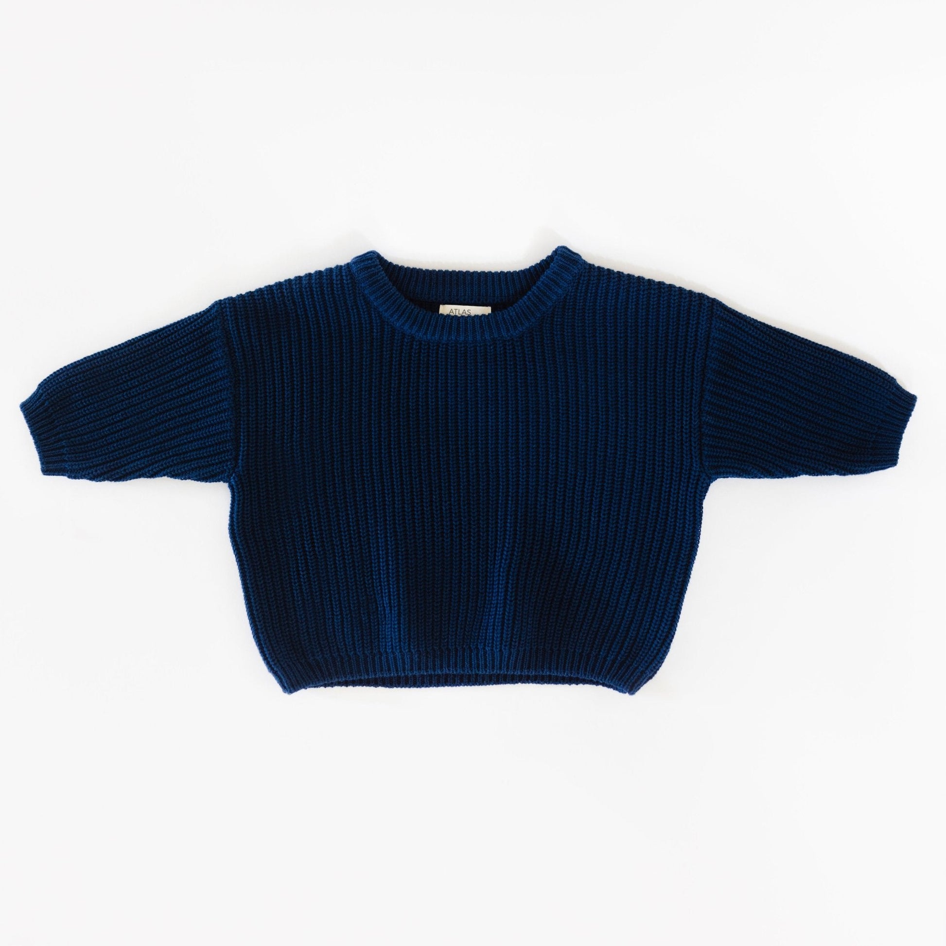 Blue ribbed sweater on a white background
