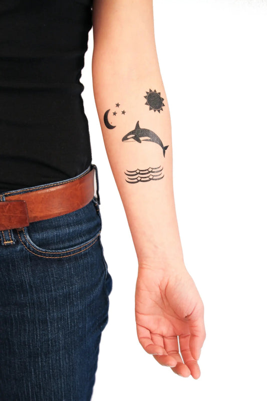 person showing their arms with PNW temporary tattoos on it