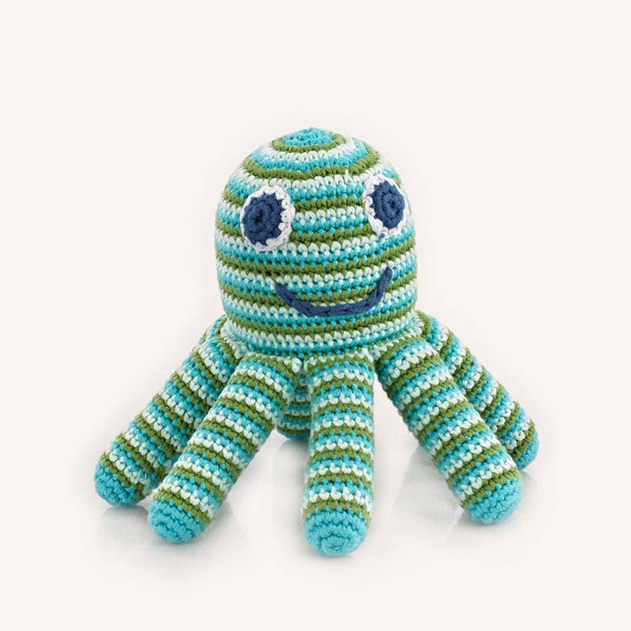 Crocheted toy octopus with blue and green stripes on a white background