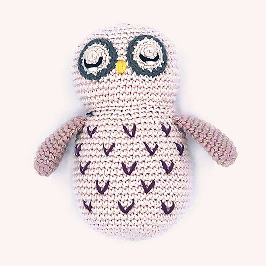 Crocheted owl plush toy with purple accents on a white background