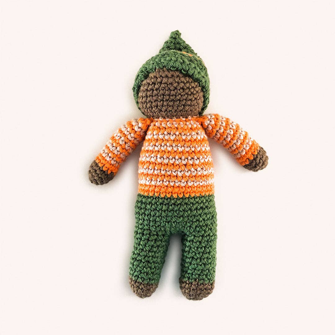 Crocheted doll with green hat, orange and white striped sweater, and green pants on a white background