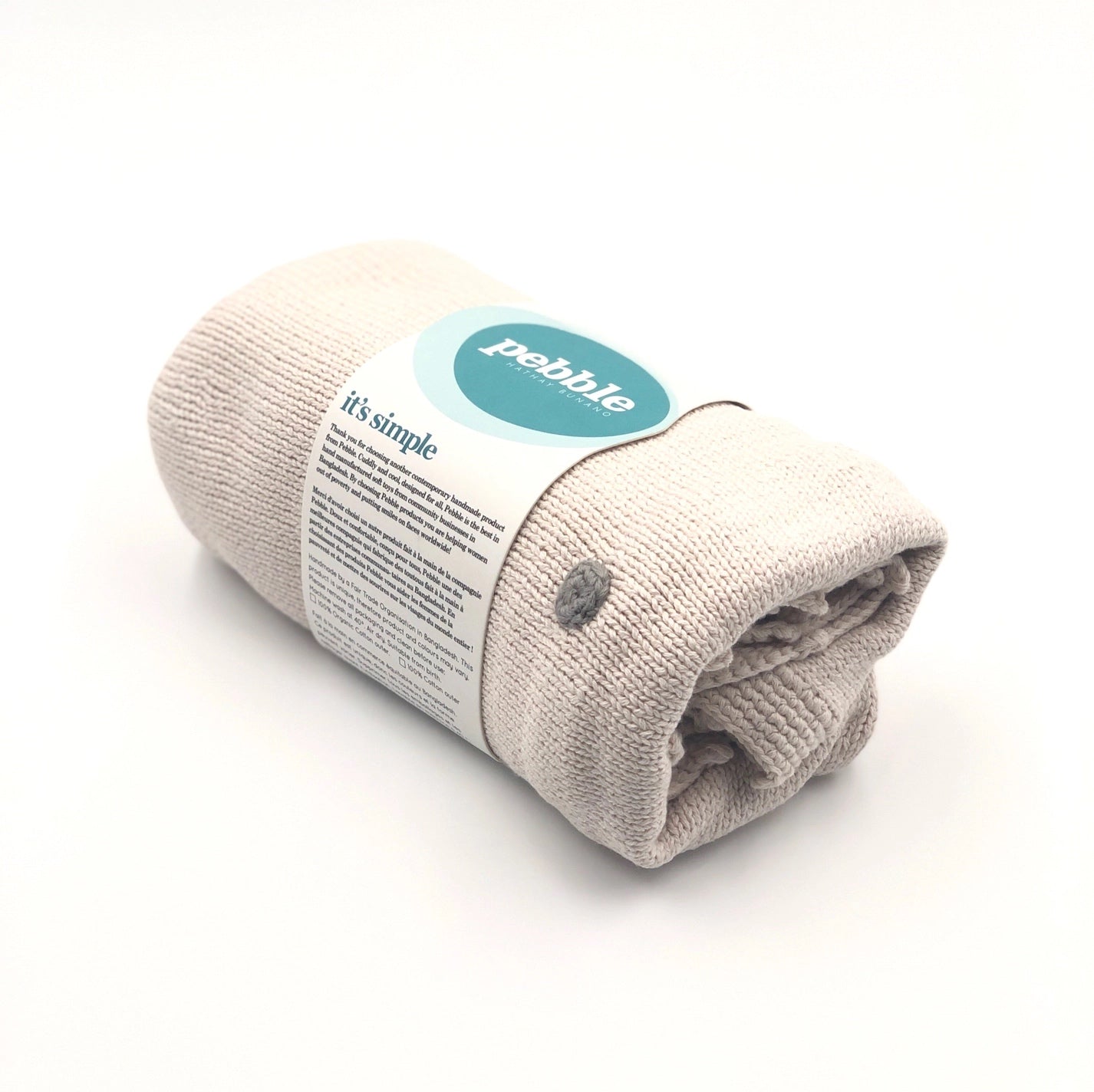 rolled beige knitted blanket with a label on a white background