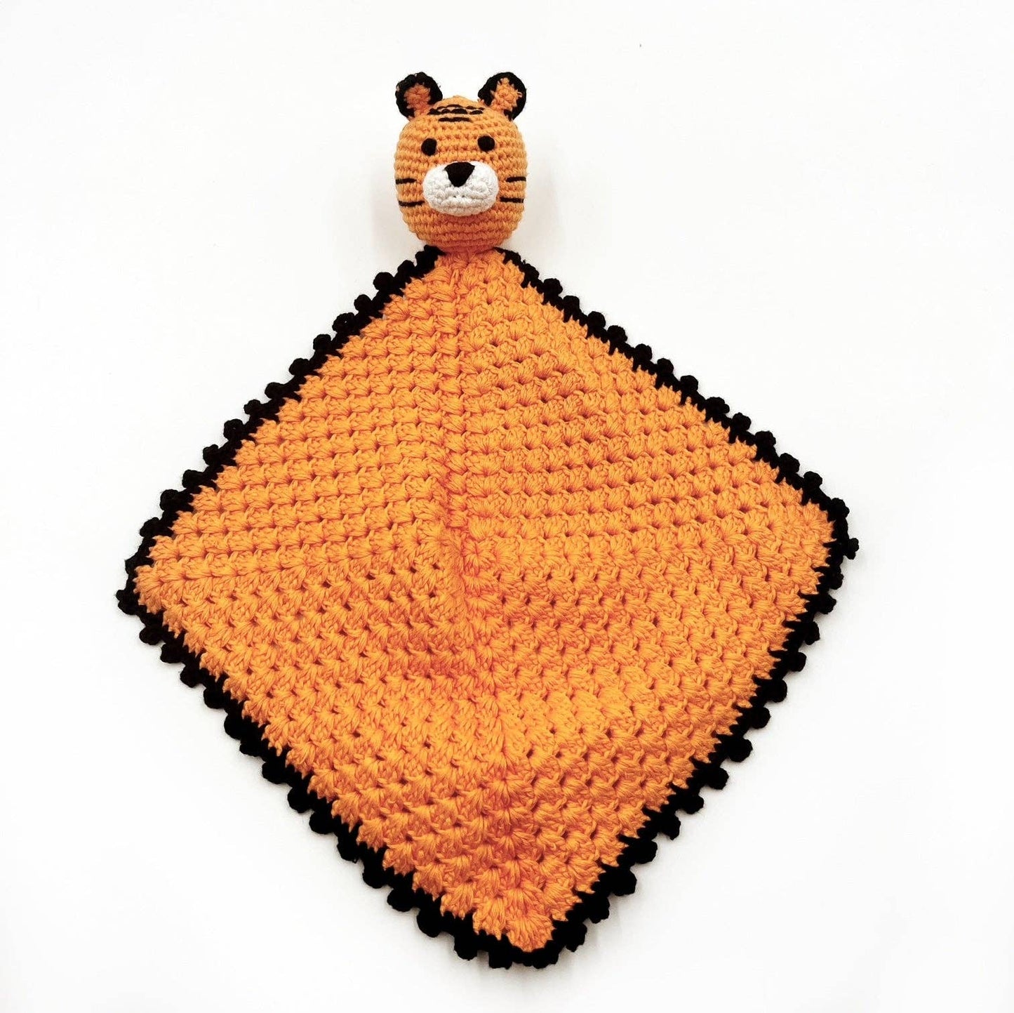 Crocheted tiger-shaped lovey on a white background