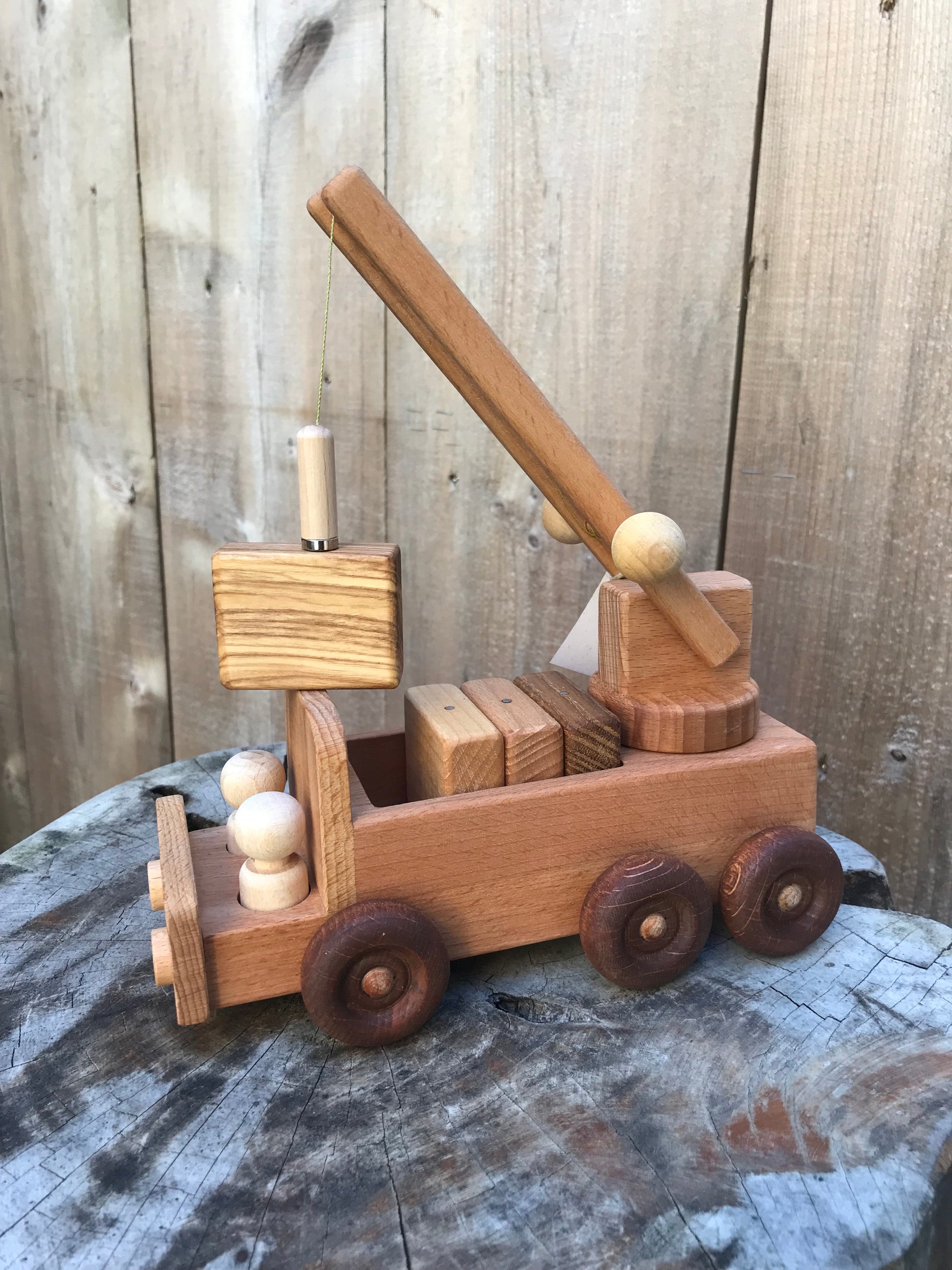 wooden crane truck toy with a block lifted up