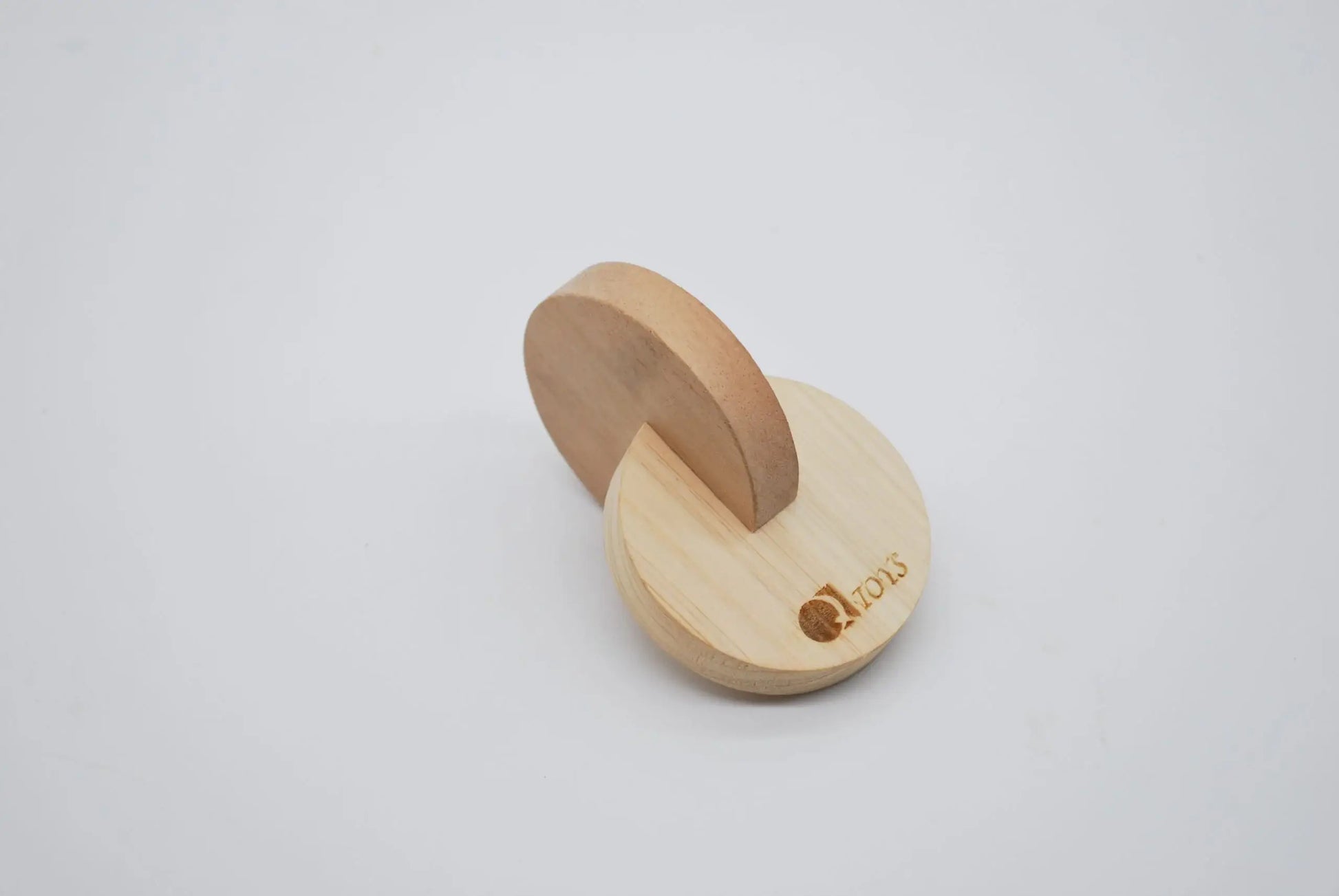 Wooden dual discs with a logo on a light gray background
