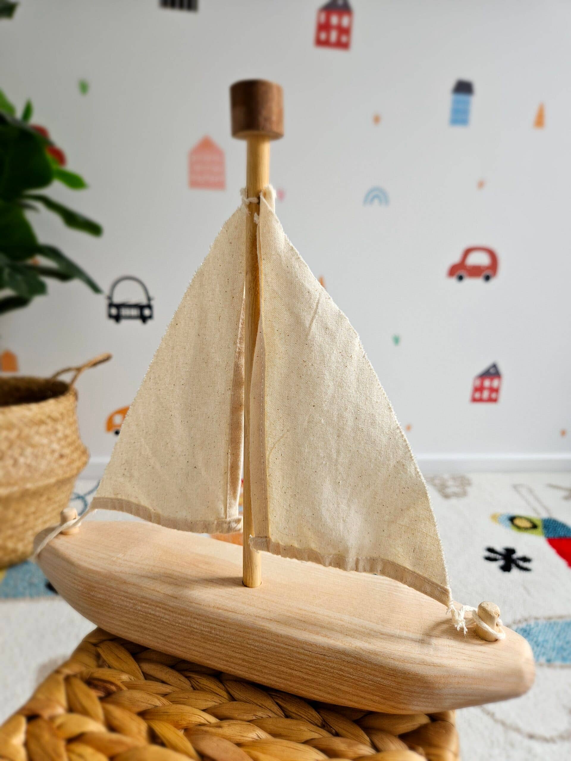 wooden recycled boat toy on a table with a plant in the background
