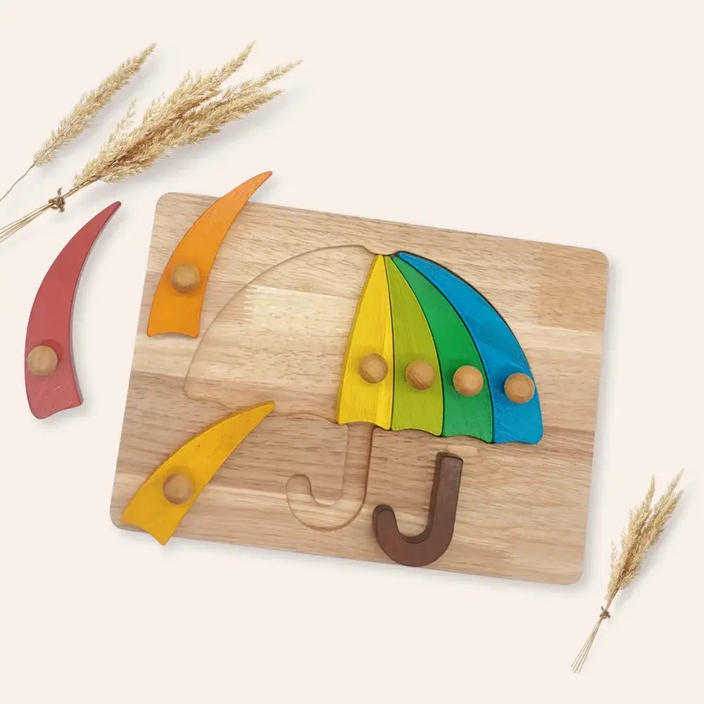 Wooden puzzle with colorful pieces on a wooden base, resembling an umbrella, on a light background.
