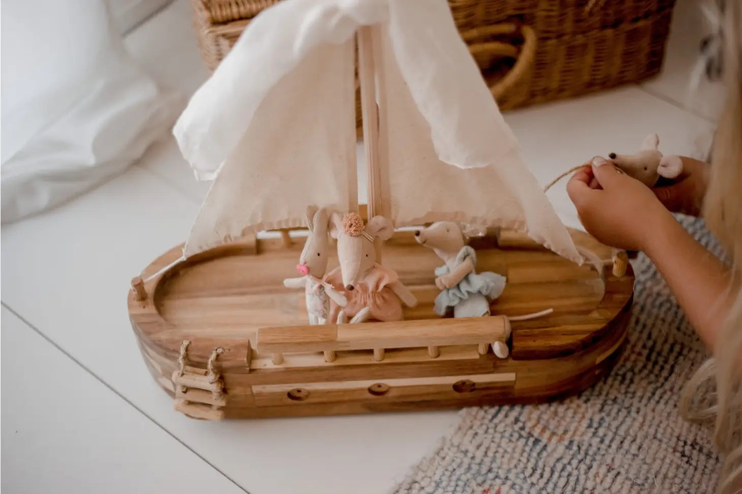 child playing with adventure ship and stuffed mice