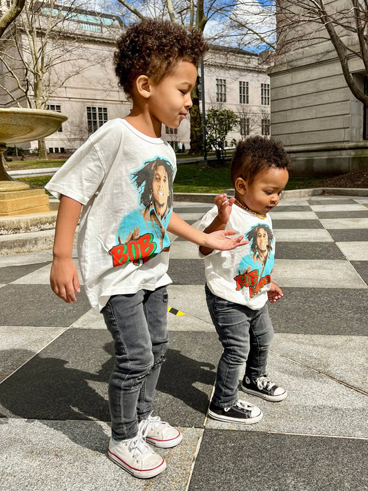 a toddler and a id wearing matching Bob Marley short sleeve tees