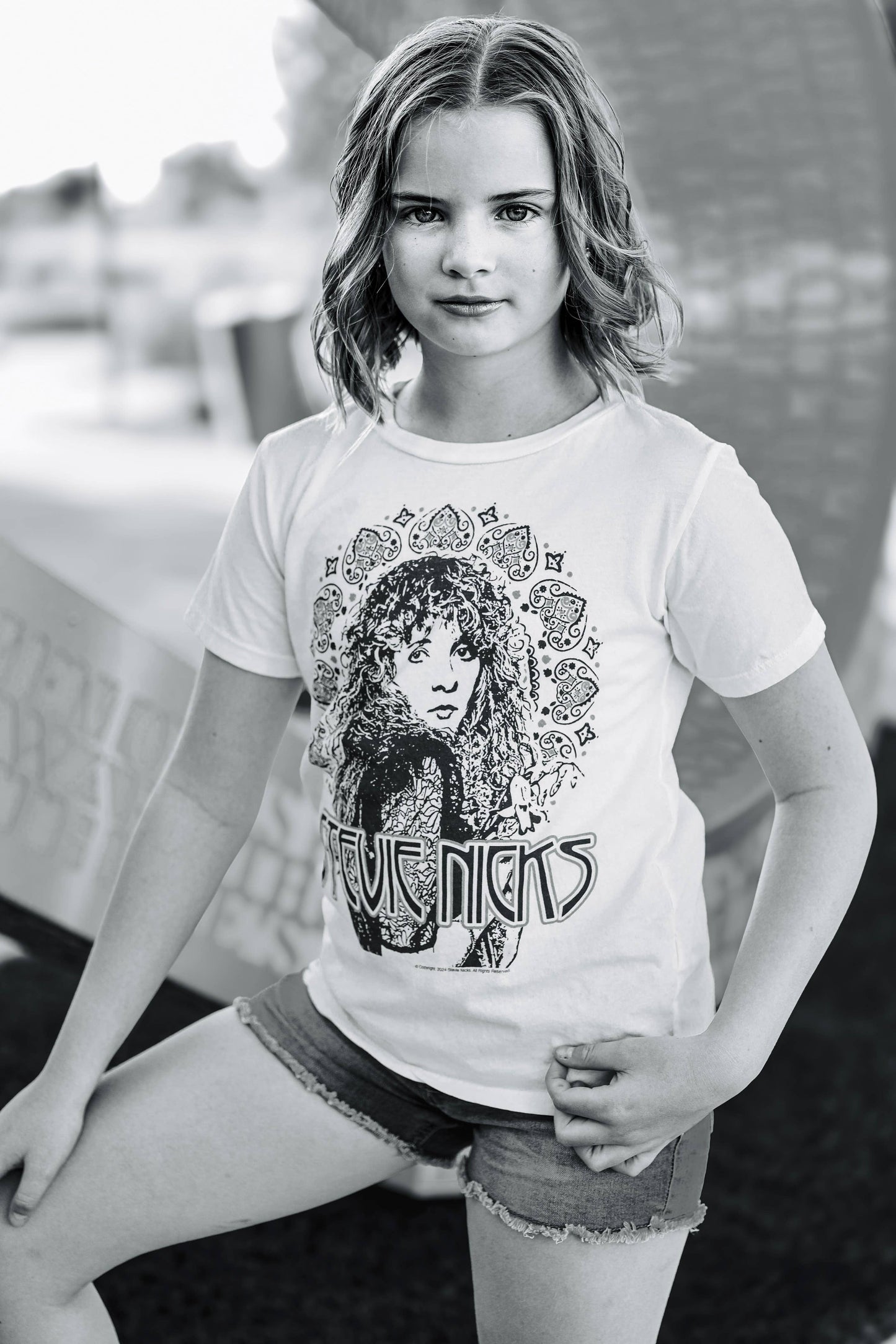 A black and white photo of a child wearing an organic Stevie Nicks tee