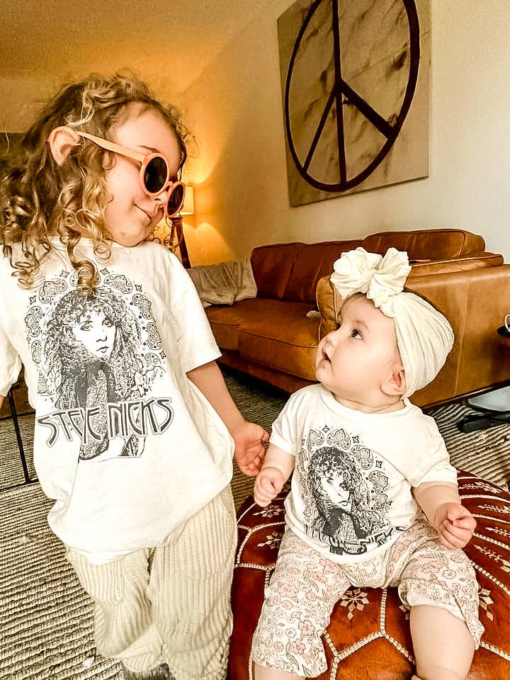 a baby and a young child wearing matching Stevie Nicks organic tees