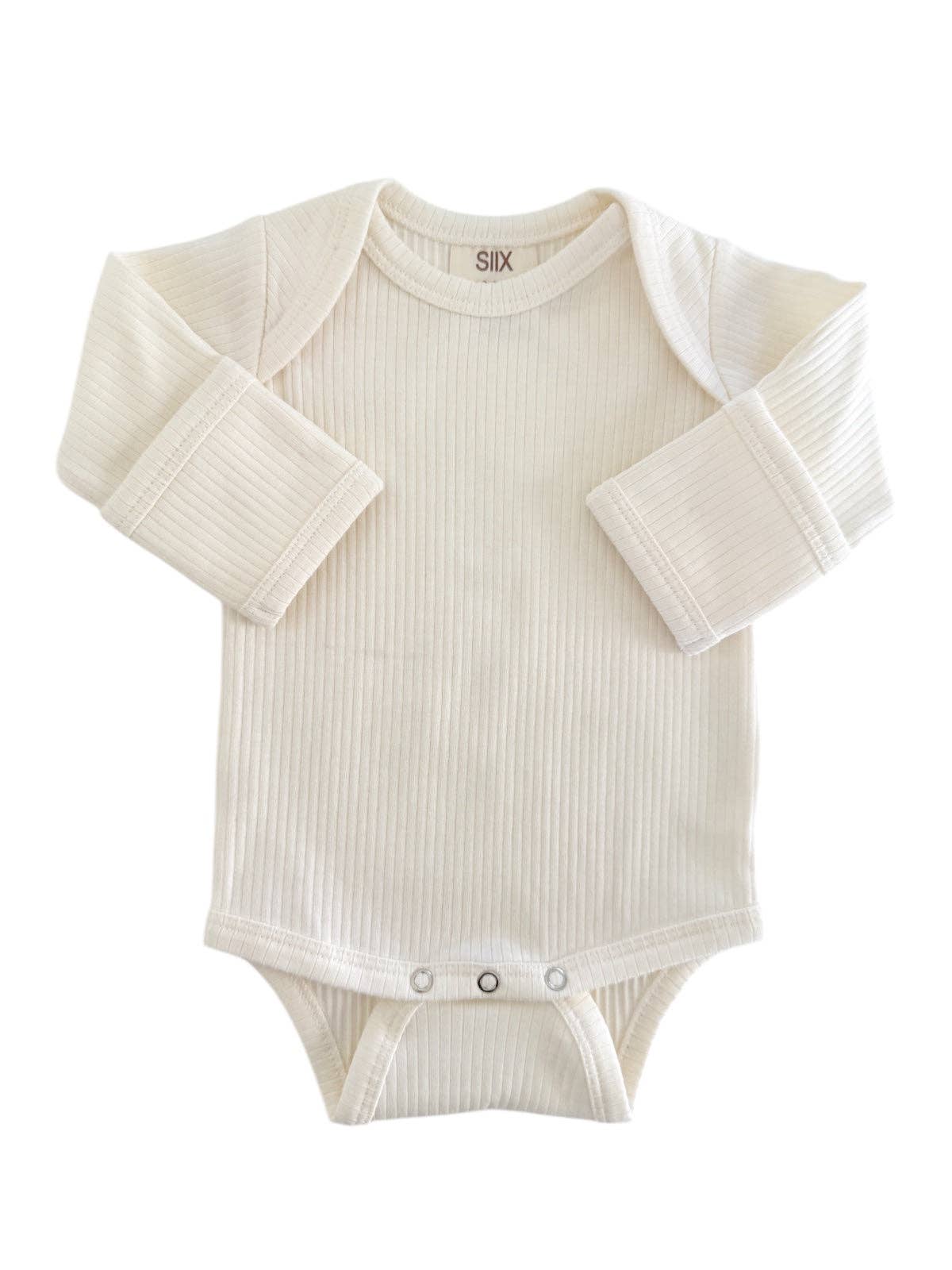 White baby onesie with long sleeves on a white background
