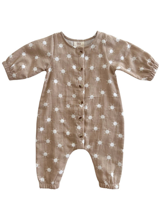 Baby romper with white suns pattern on a white background