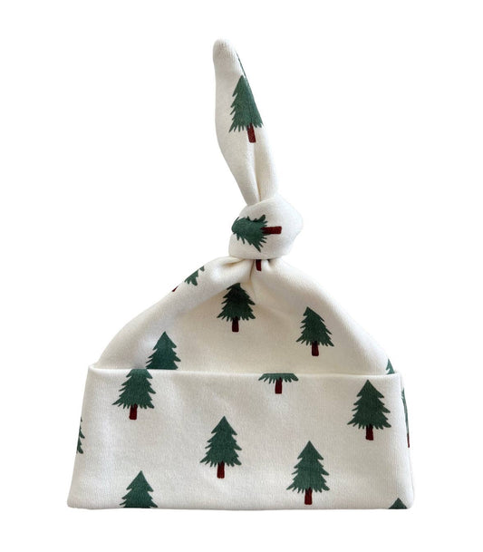 Baby hat with green tree pattern on a white background