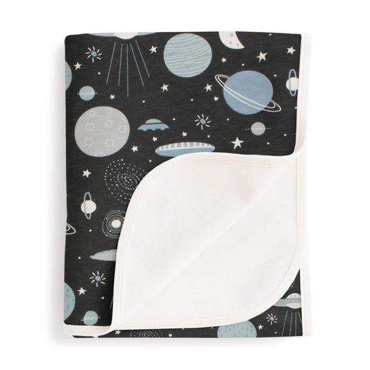 Blanket with space-themed pattern on a white background