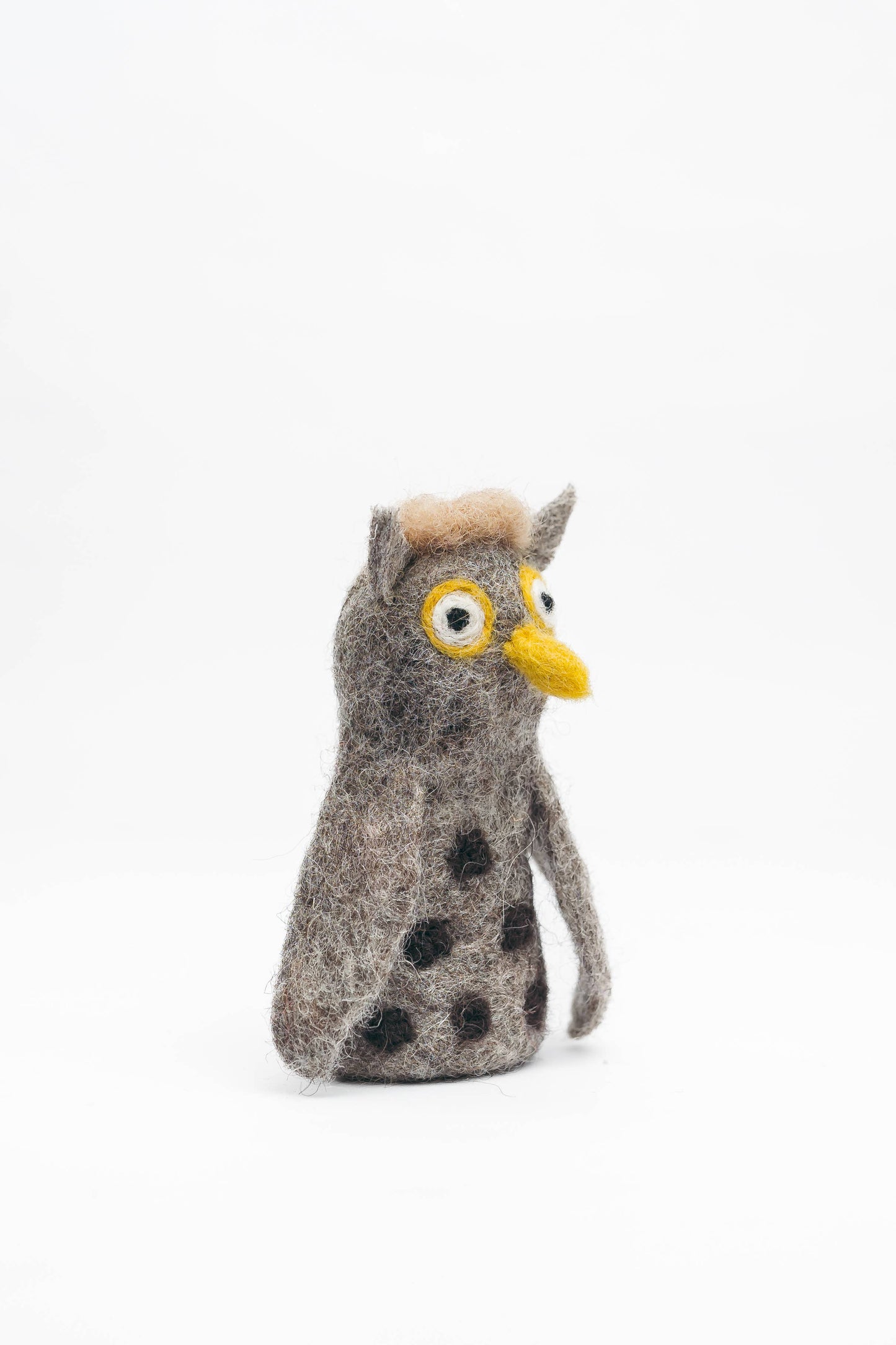 Stuffed owl finger puppet with a white background