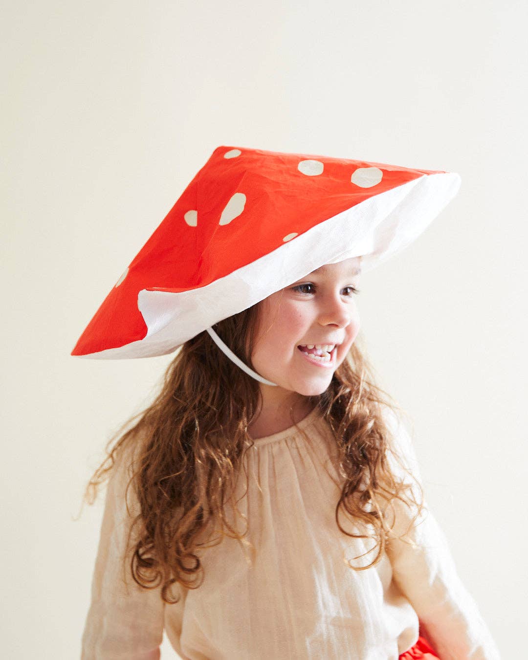 Child wearing a silk mushroom hat