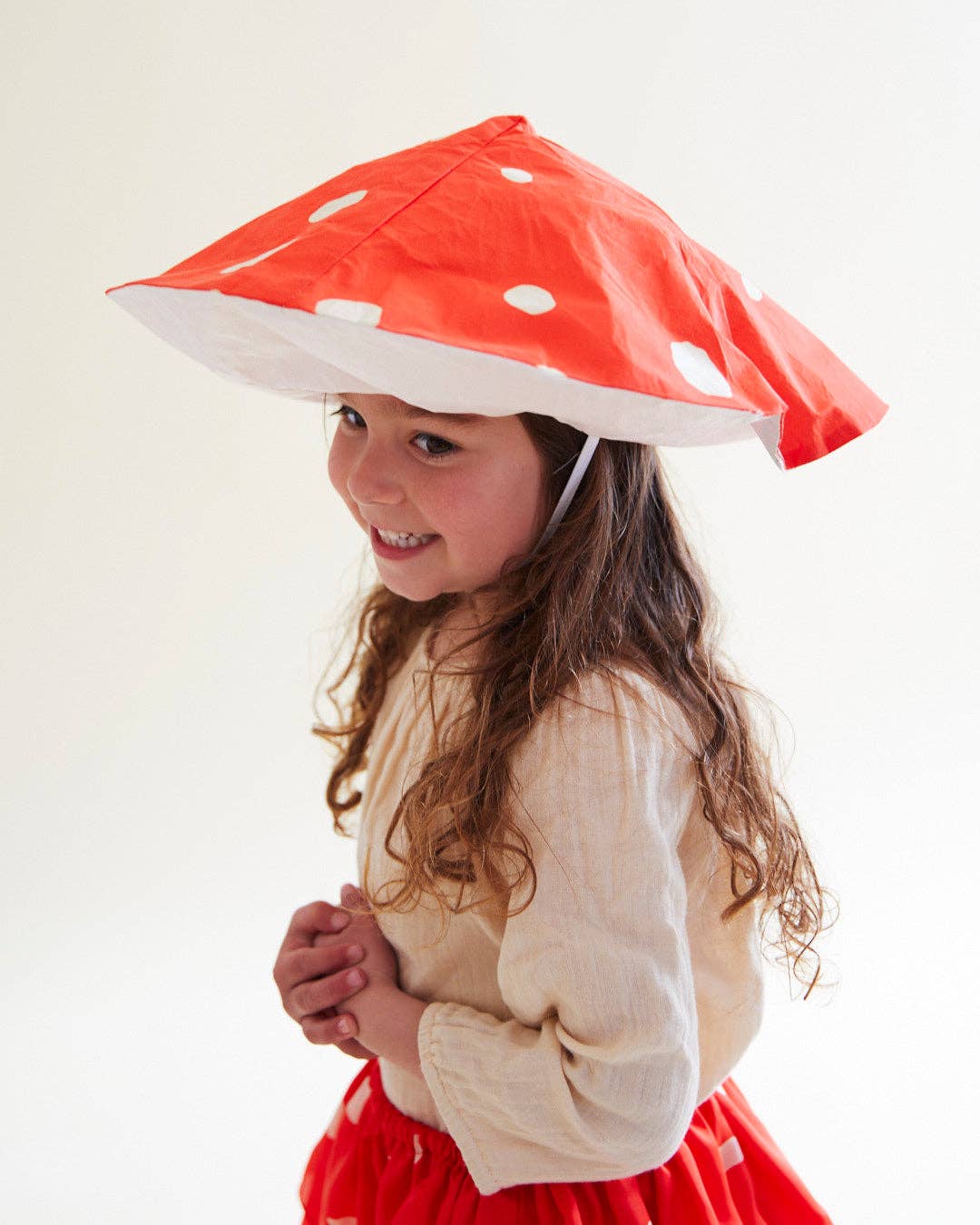 Child wearing a silk mushroom outfit with hat and tutu