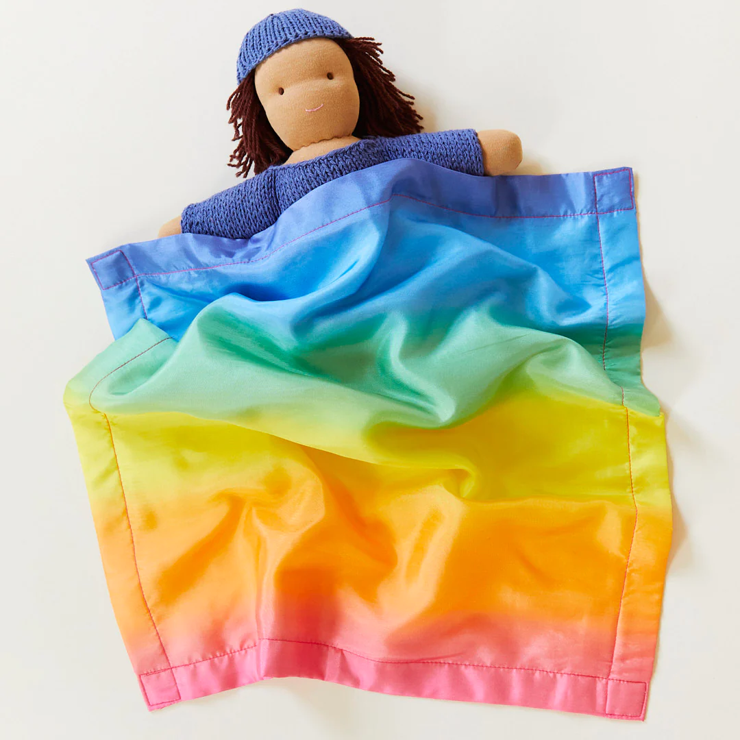 Silk rainbow lovey on a doll