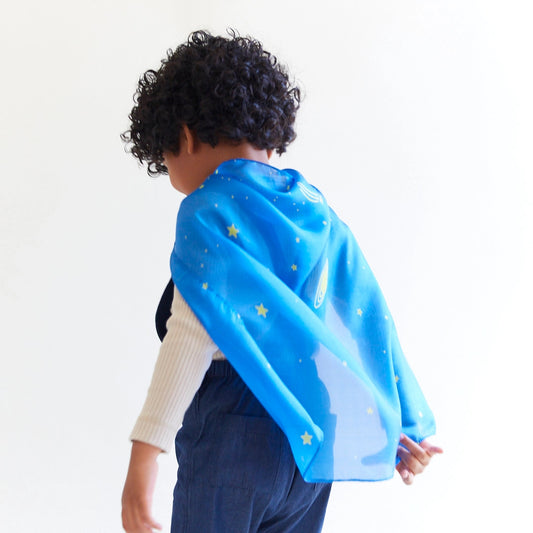 Child wearing mini starry night playsilk as a cape