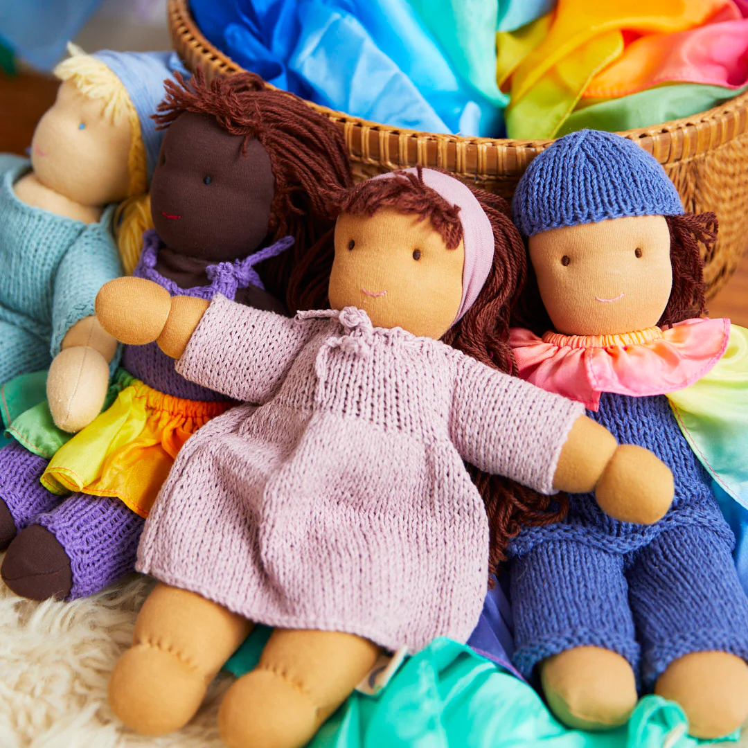 Organic Waldorf dolls by Sarah's Silks propped up next to a basket