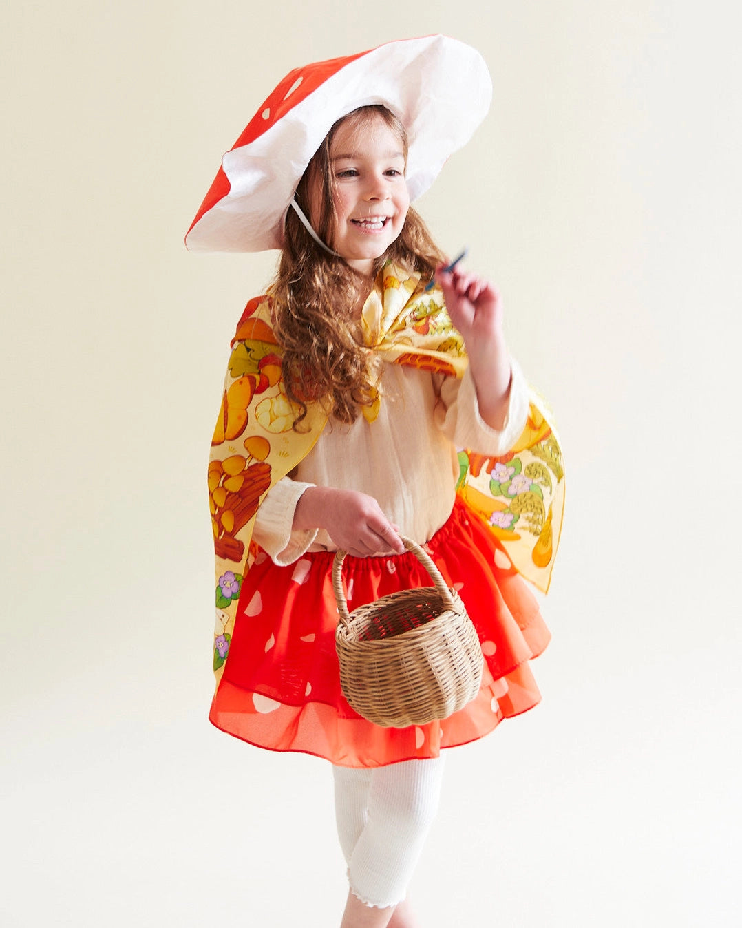 Child wearing Mushroom Print Seek & Find Playsilk and a cape for their mushroom costume