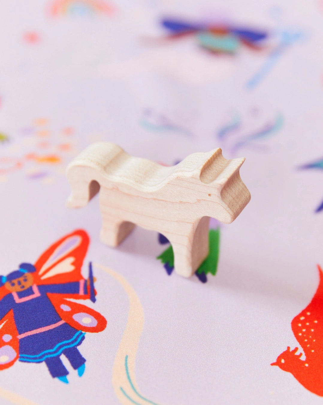 Maple wood unicorn on a playsilk
