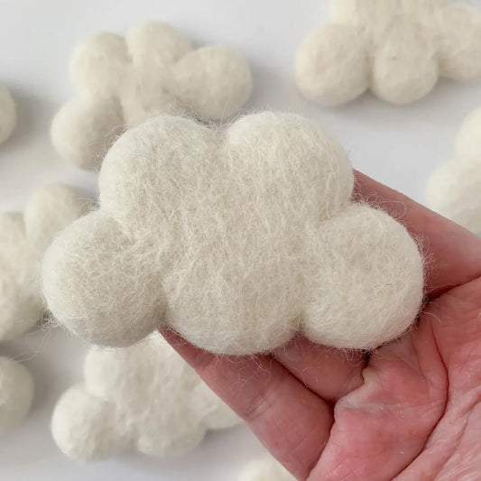 hand holding a white felt cloud