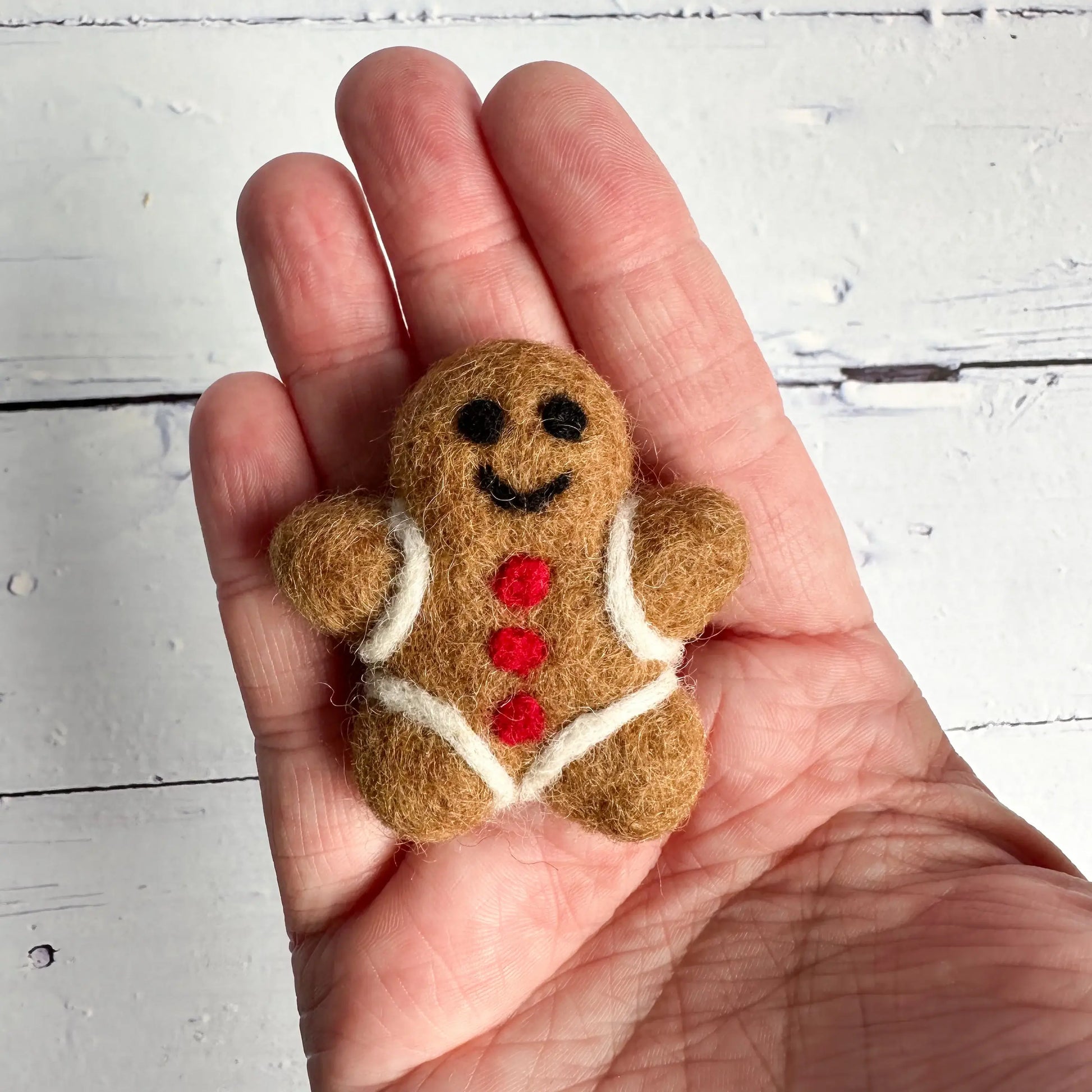 hand holding a mini gingerbread person