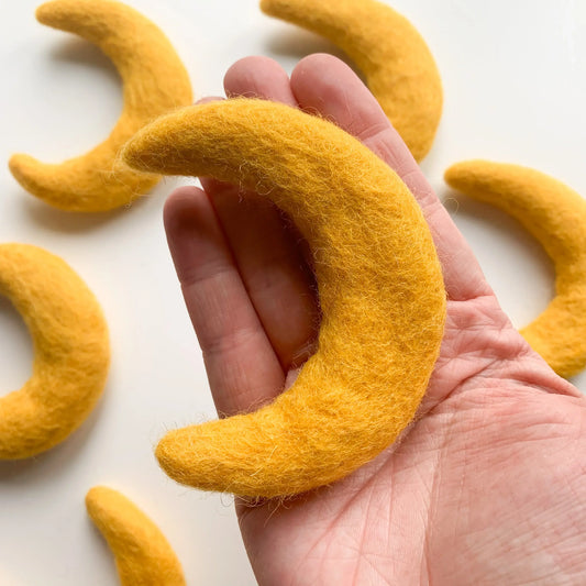 hand holding a felt gold moon