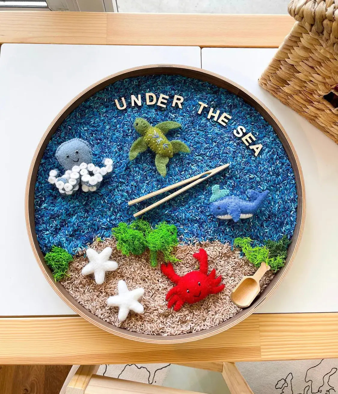 round decor tray with colored rice and felt ocean animals