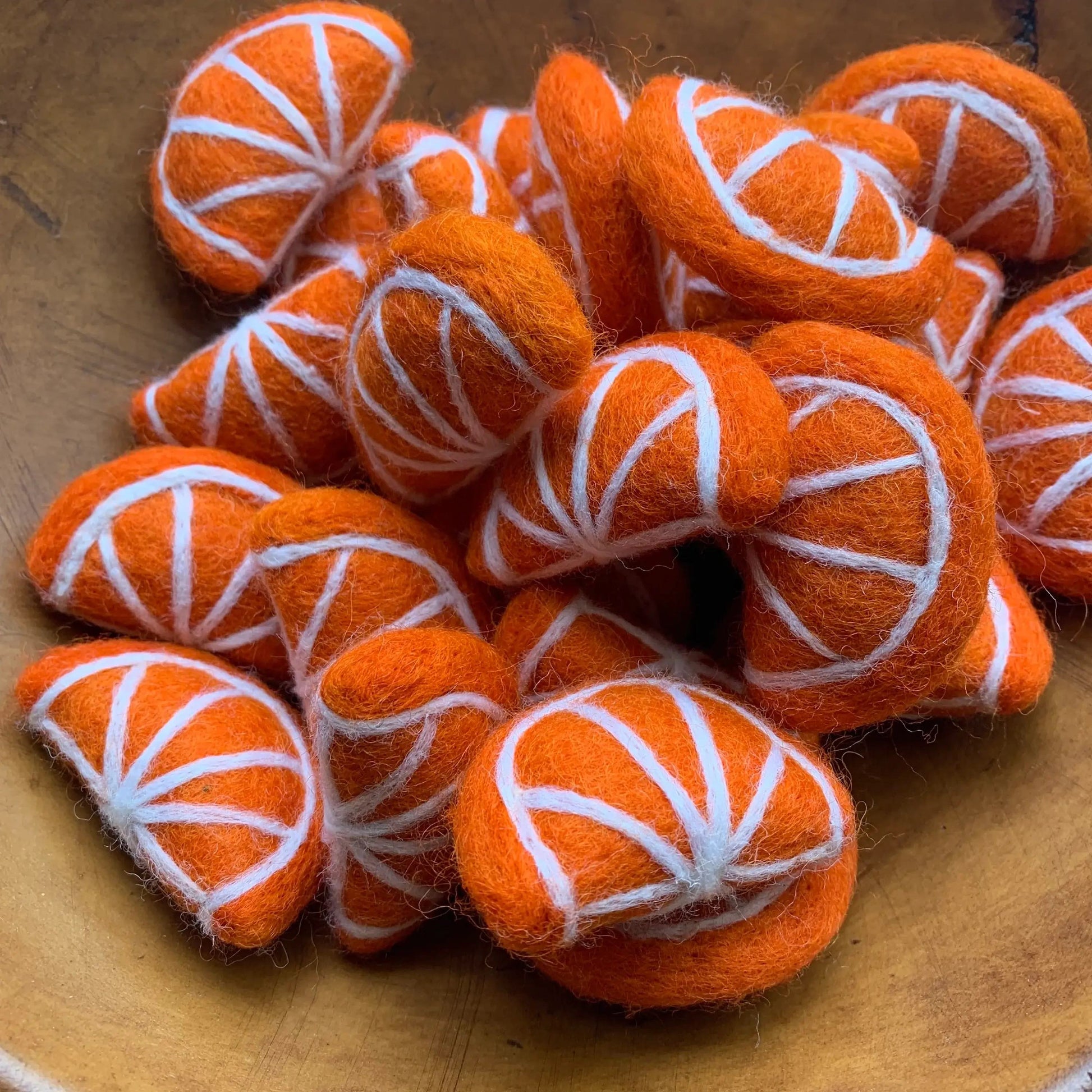 felt orange slices in a paper bag