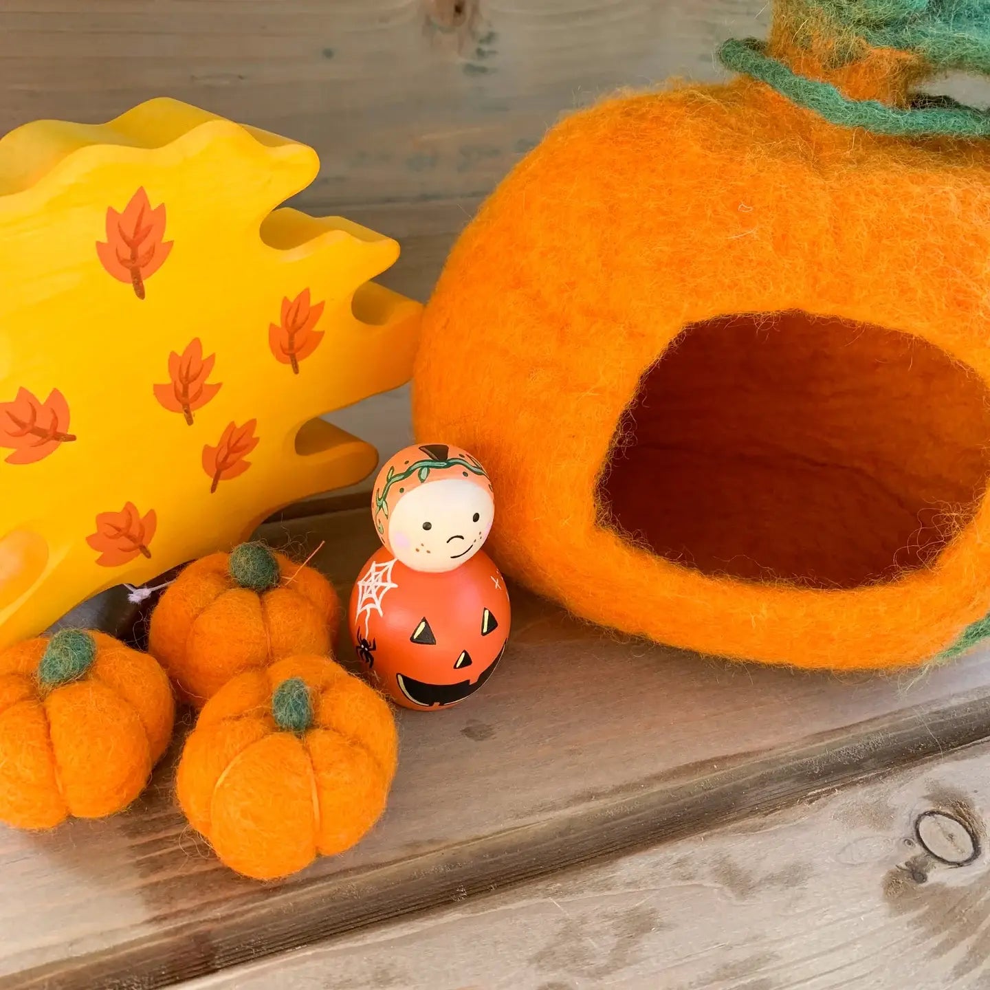 Scene with pumpkin cottage, felt mini pumpkins and wooden figures